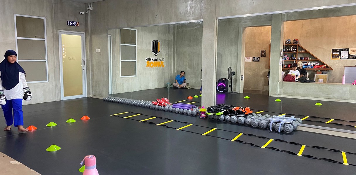 Indoor kids academy floor at Gatsu Junior set up with agility ladders and cones